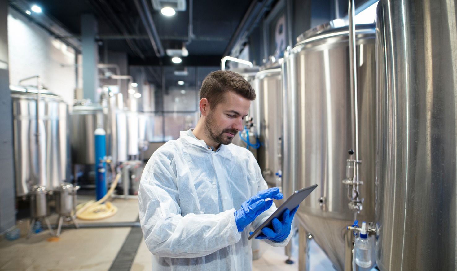 An industrial worker using a tablet for managing work data