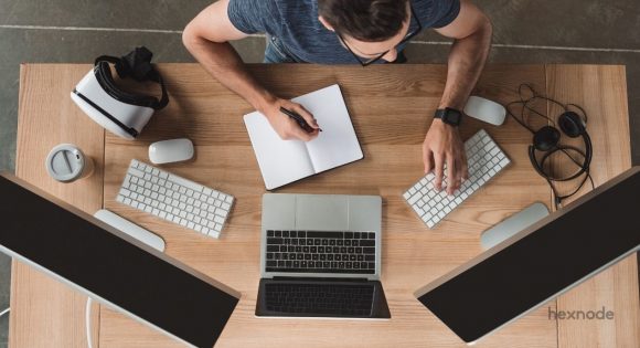 Employee working on multiple devices to complete his tasks