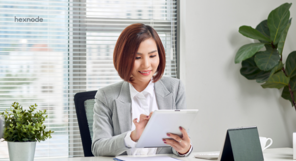 Female employee is happy using iPad at work