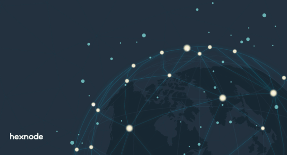 A glowing worldwide network map on a blue background representing the process of scaling enterprise endpoint management across a distributed workforce.