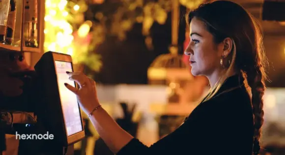 Image of a person using self-service kiosk in a cafe