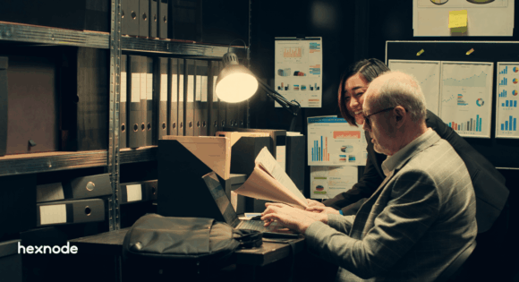 IT and security professionals reviewing endpoint compliance reports for a SOC 2 audit