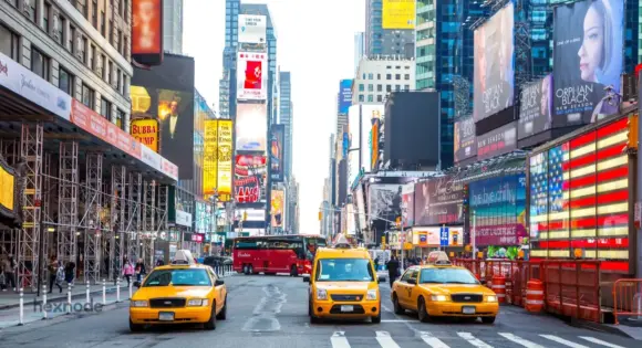 Image of a street having a lot of digital signage screens.