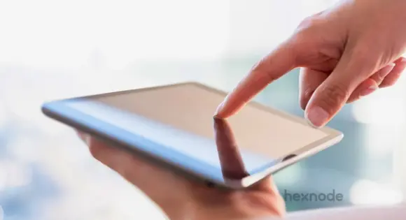Image of a person holding a device locked in single app mode